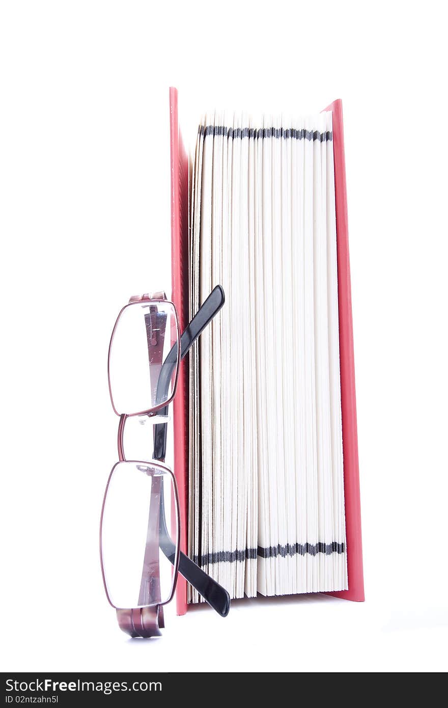 Red open book and eyeglasses against white background