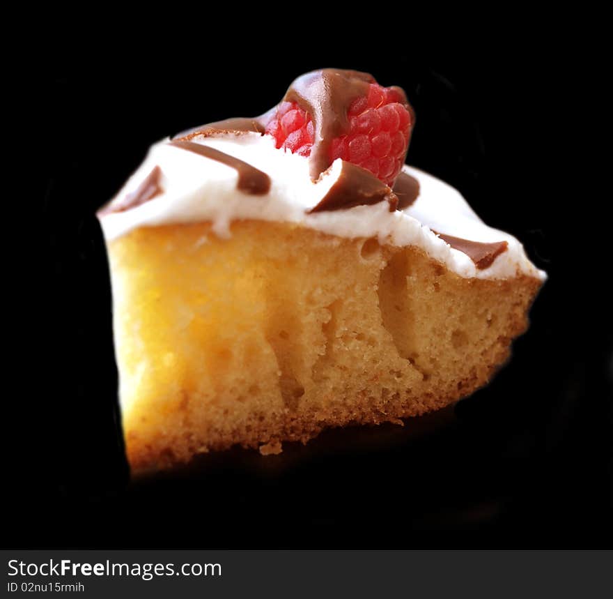 Delicious raspberry pie with a couverture on a black background