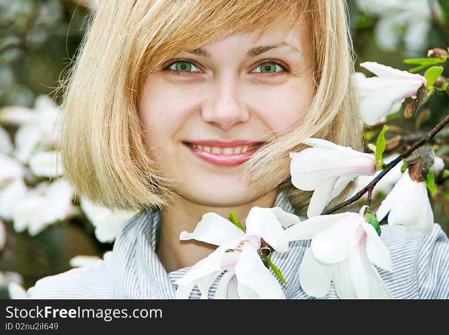 Young girl with magnolia