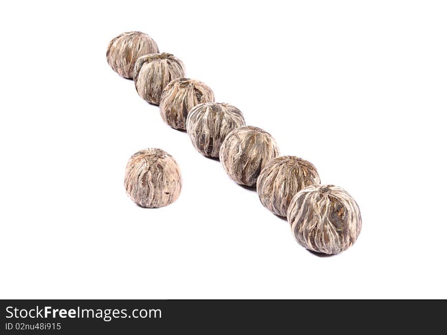 Balls of white tea over white background