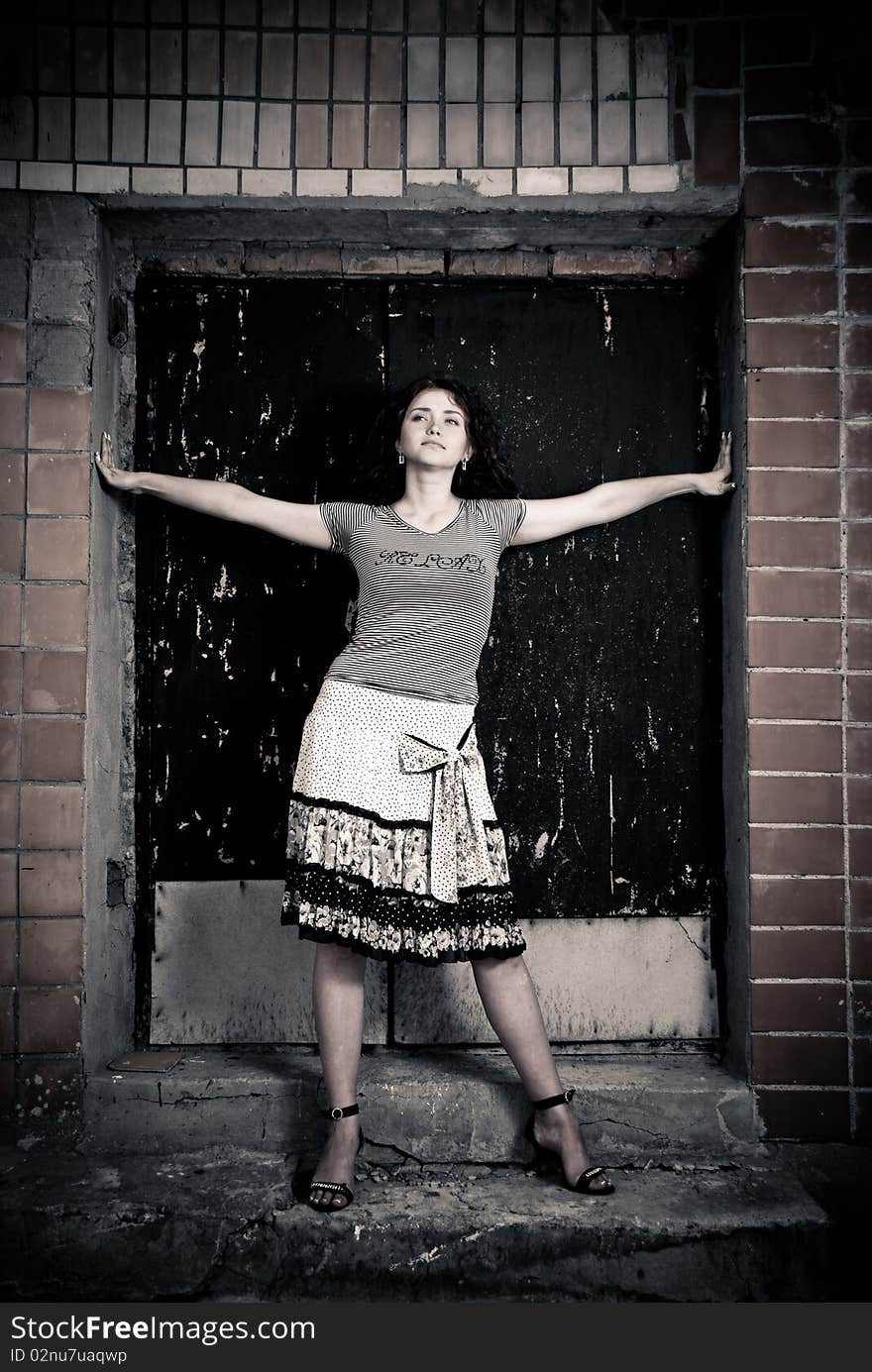 Young woman standing at old doorway. Young woman standing at old doorway