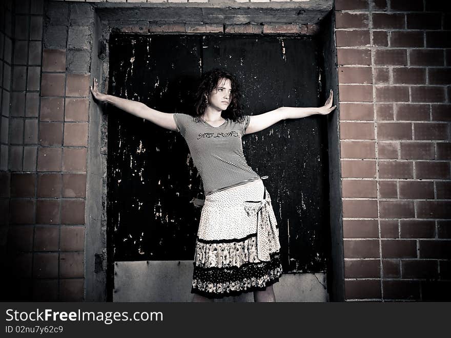 Young woman standing at old doorway. Young woman standing at old doorway