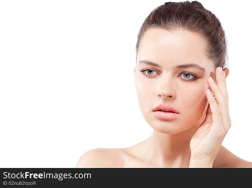 Studio portrait of beautiful young passionate brunette woman touching face with fingers