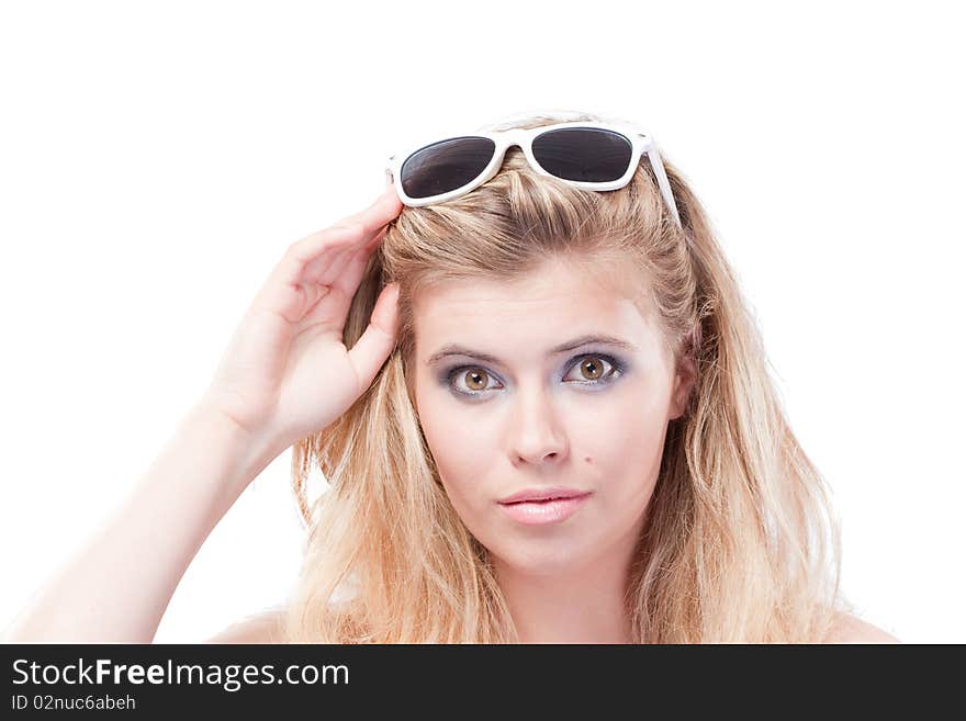 Closeup portrait of beautiful blonde woman holding glasses on head