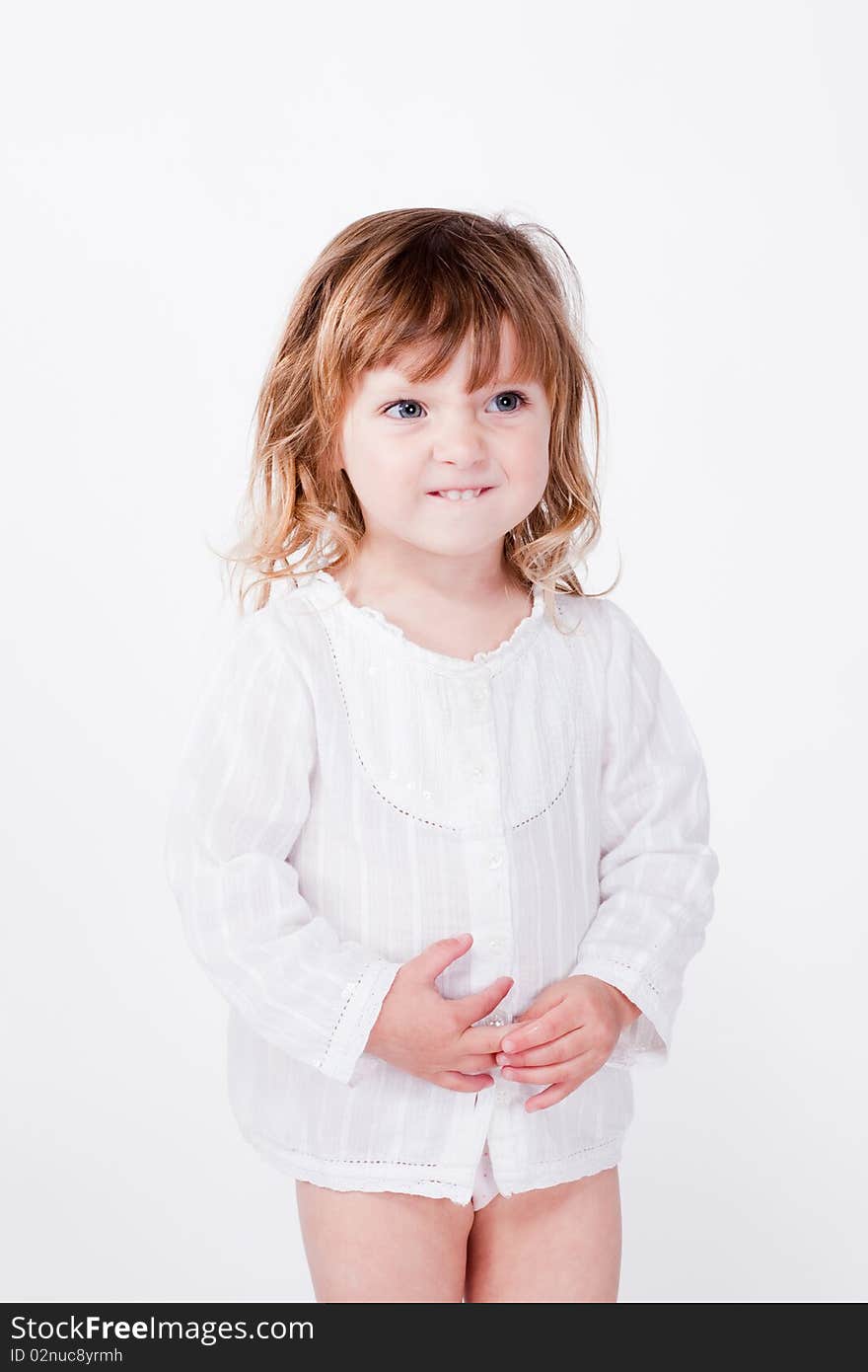 Studio closeup portrait of funny cute playful child showing teeth