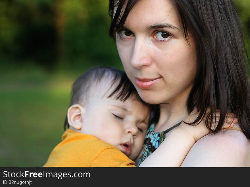 Year-old boy fell asleep on the shoulder of his mother. Year-old boy fell asleep on the shoulder of his mother