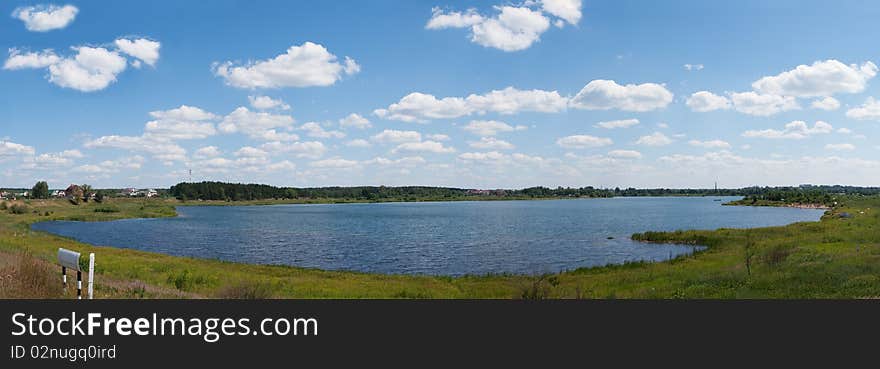 Panoramic lake the sky and clouds. Panoramic lake the sky and clouds