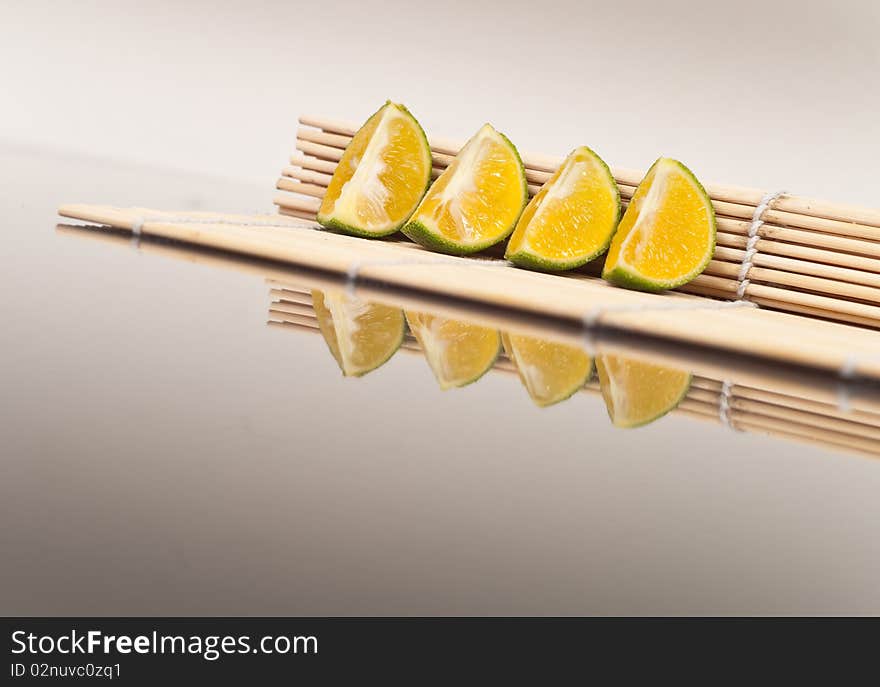 Sliced Limes on Bamboo Mat. Sliced Limes on Bamboo Mat