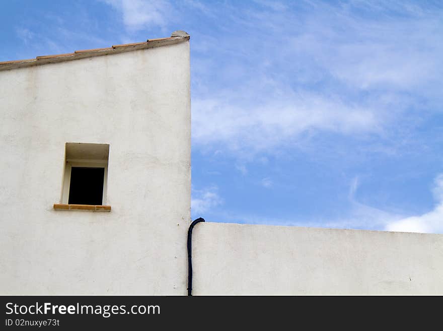 Window of a white house with blue sky