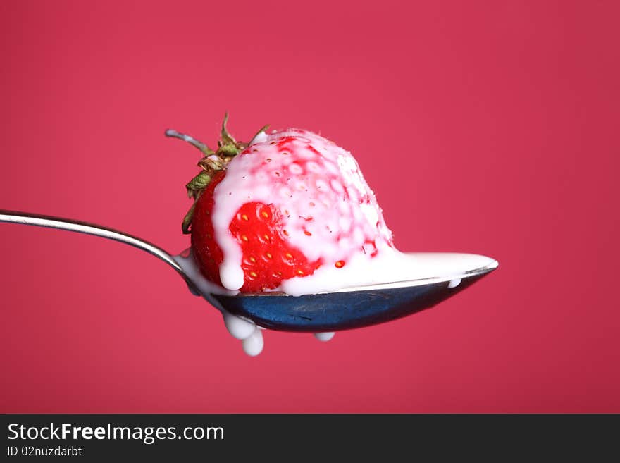 Close-up view of fresh strawberry with cream. Close-up view of fresh strawberry with cream