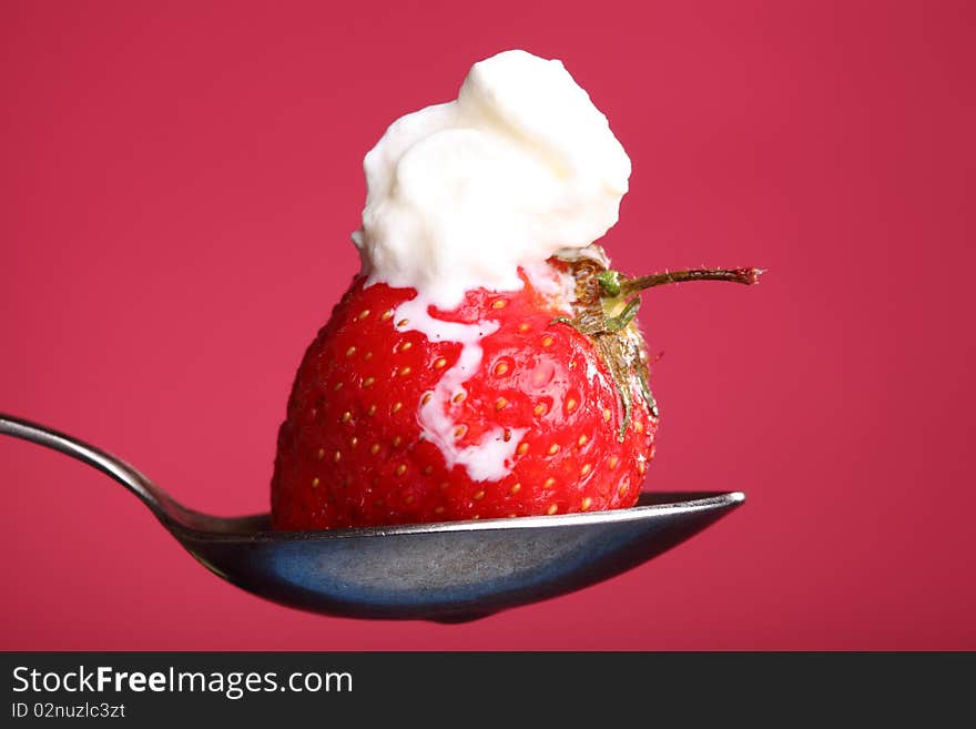 Close-up view of fresh strawberry with cream. Close-up view of fresh strawberry with cream