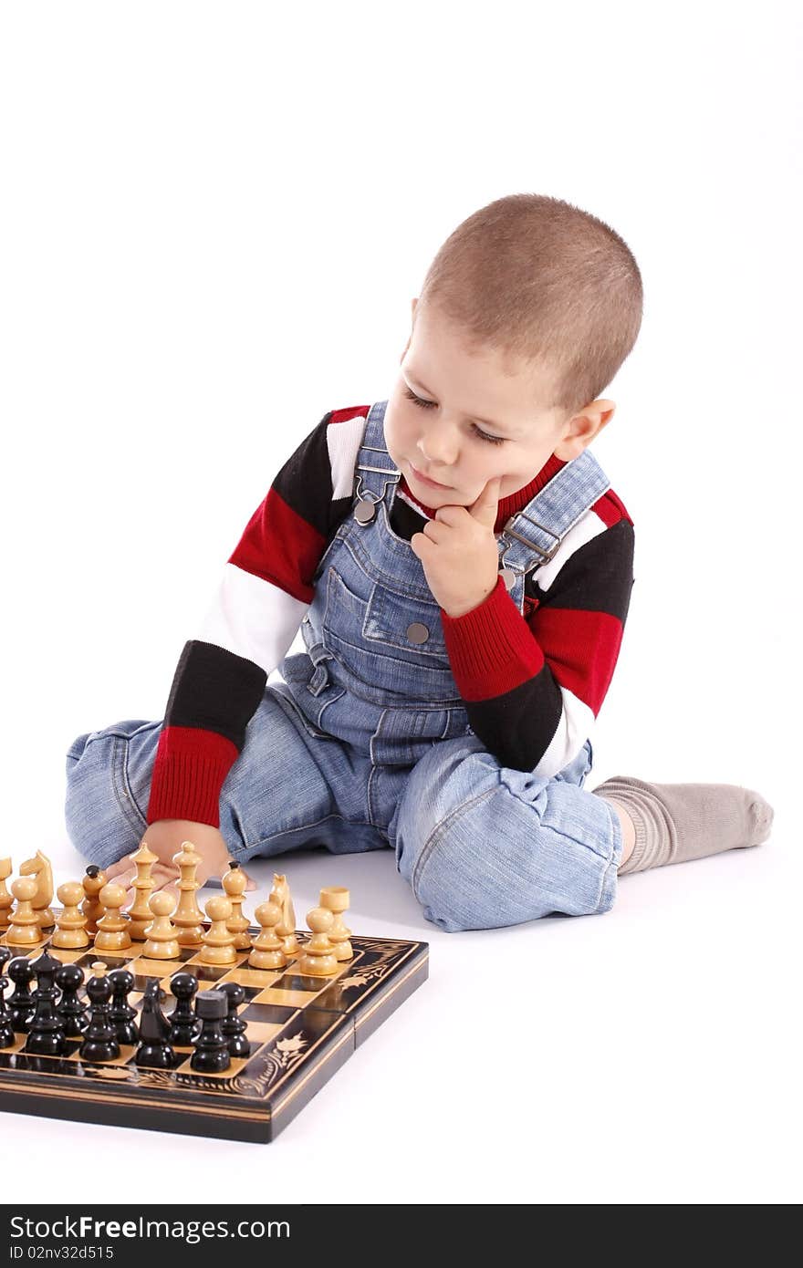 Childre playing with chess in white background, studio shot. Childre playing with chess in white background, studio shot