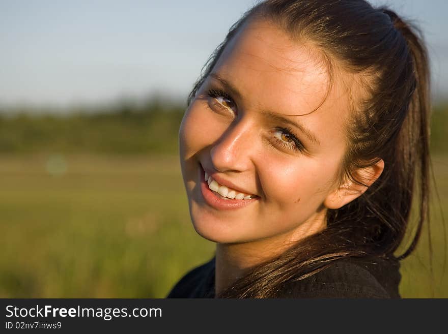 Young college age smiling beautiful brunette. Young college age smiling beautiful brunette