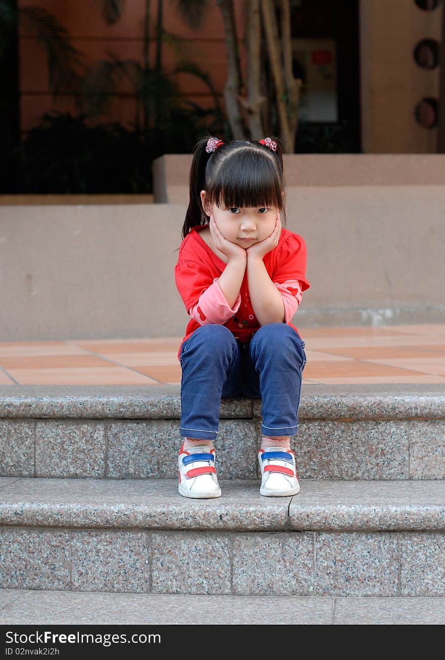 Asian child Sitting on the steps