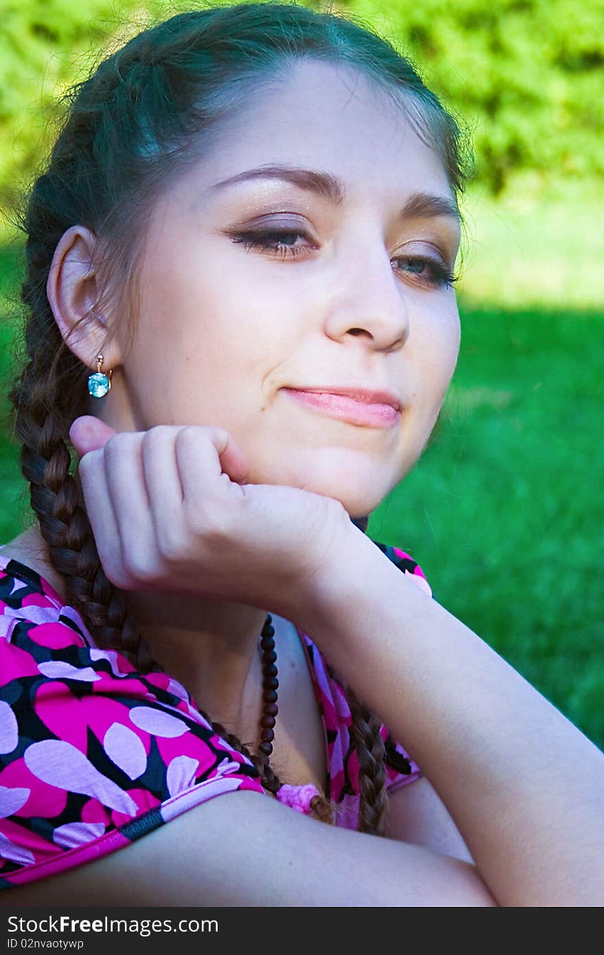 The beautiful girl sitting on a grass. The beautiful girl sitting on a grass