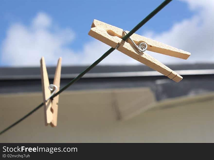 Picture of two clothespins on clothes line.