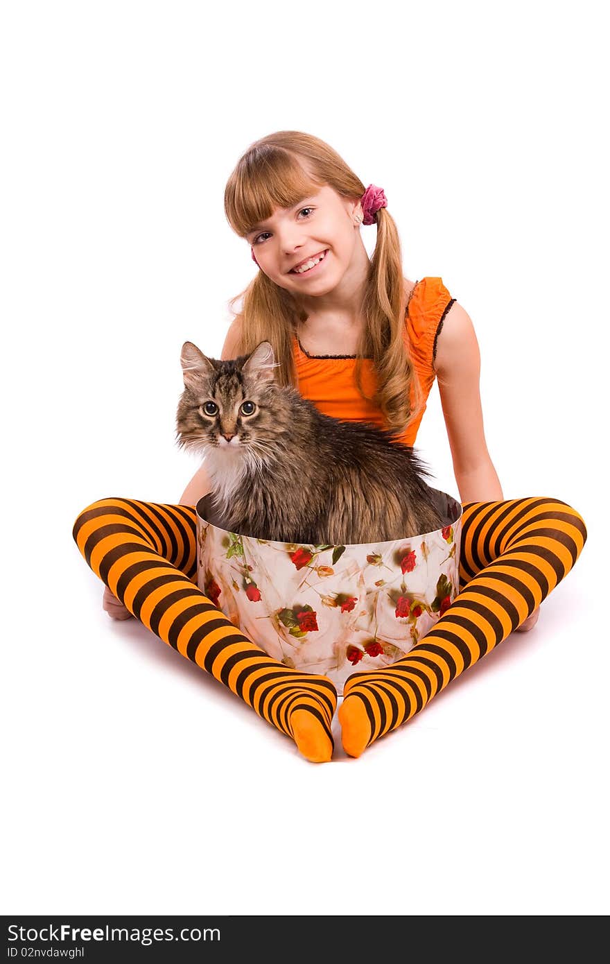 Little girl in the orange dress is sitting on the floor. Portrait of an attractive young teenager is smiling in orange over white background. Little girl in the orange dress is sitting on the floor. Portrait of an attractive young teenager is smiling in orange over white background.