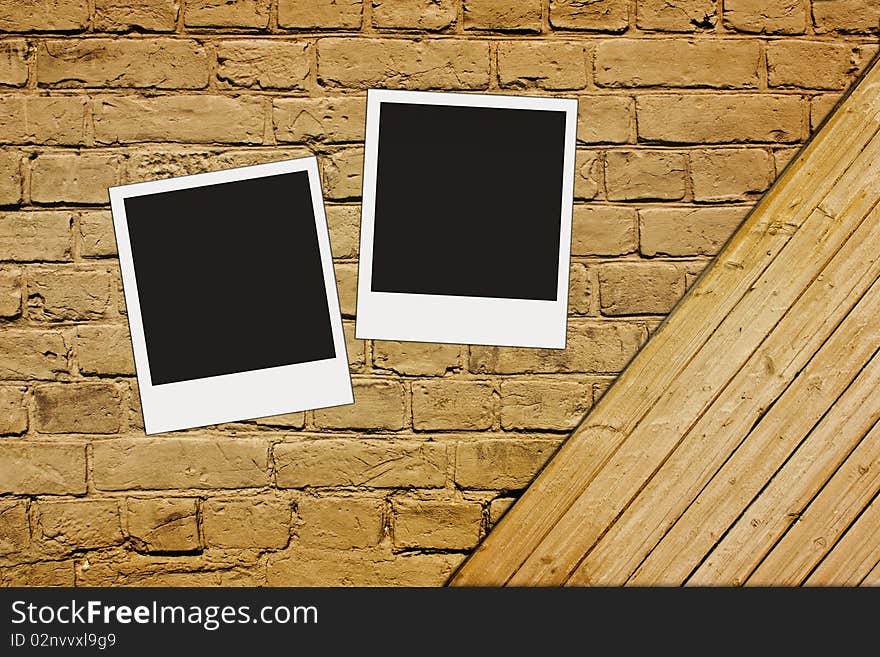 Blank photos on vintage brown textured brick and wooden wall