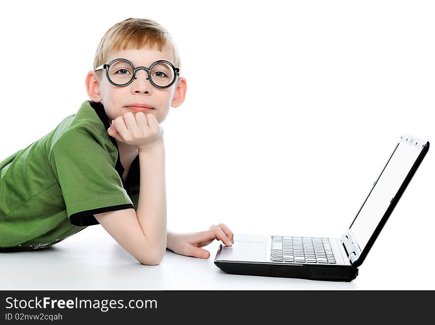 Shot of a boy lying on a floor with his laptop. Isolated over white background. Shot of a boy lying on a floor with his laptop. Isolated over white background.