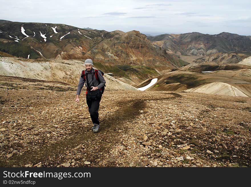 Young male traveller, photographer hiking in Landmannalaugar region of Iceland