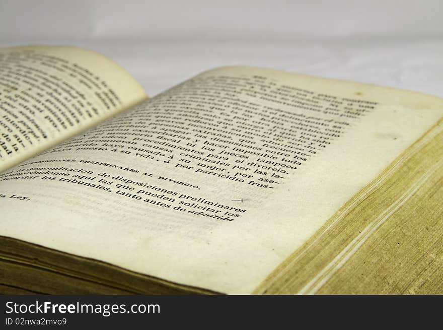 This image shows an old ancient book, half open. This image shows an old ancient book, half open