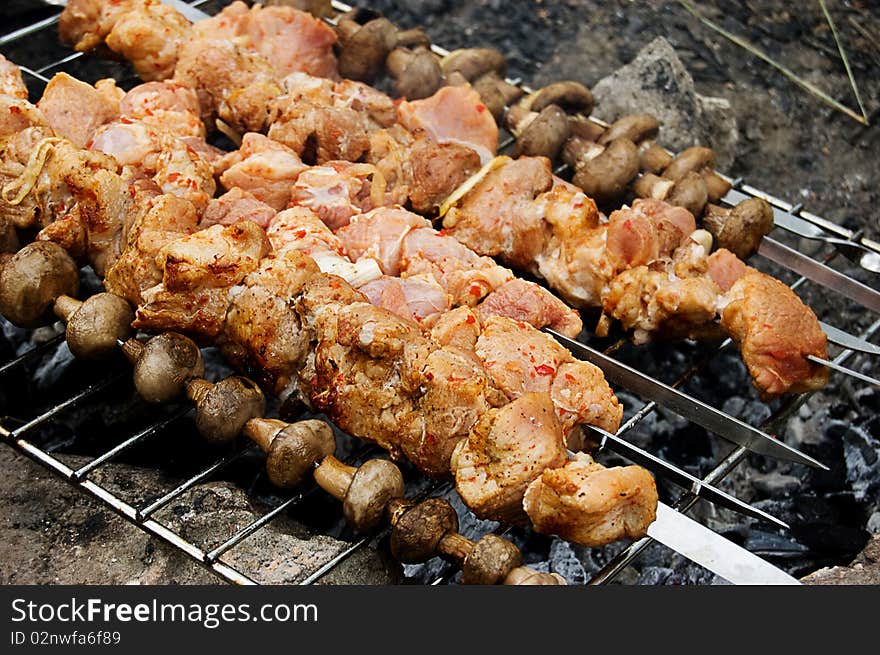 Barbecue with grilled meat and mushrooms