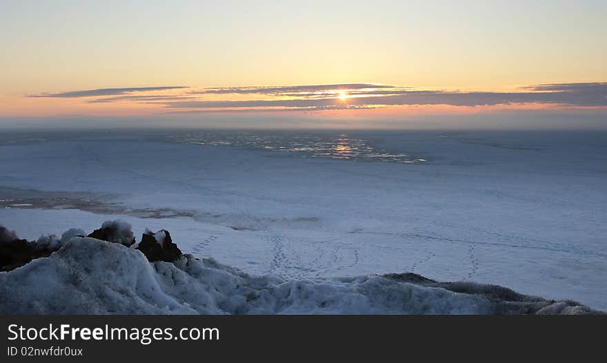 Sunrise over a water basin in the winter