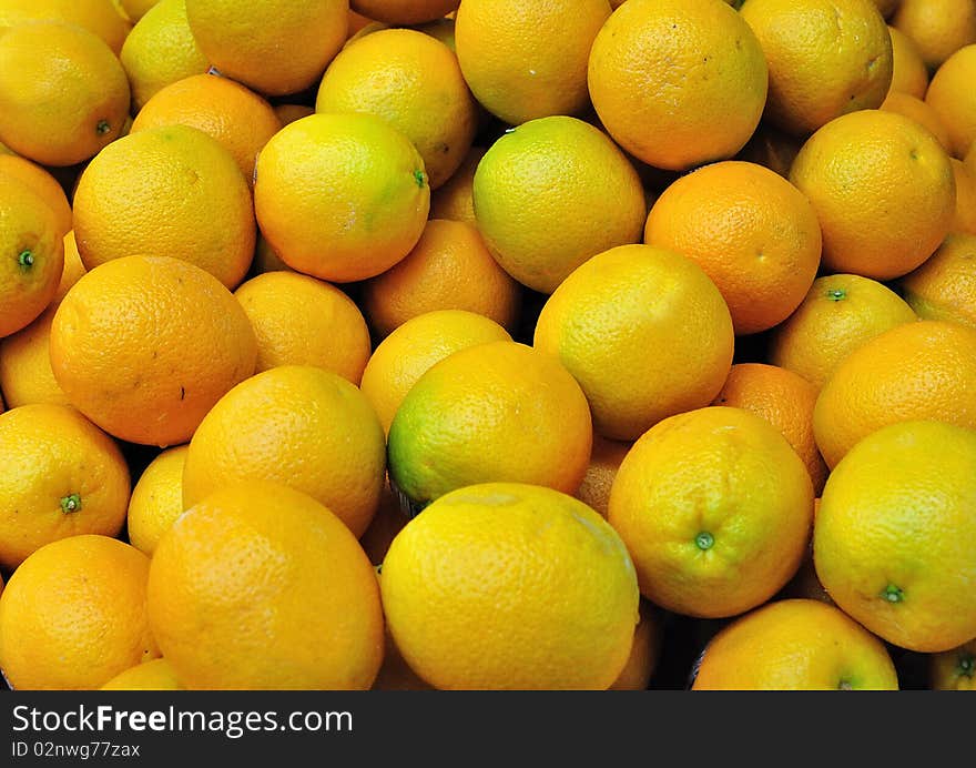 A pile of fresh unpeeled oranges shot at a Hong Kong market