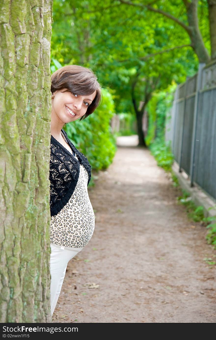 Pregnant woman near tree