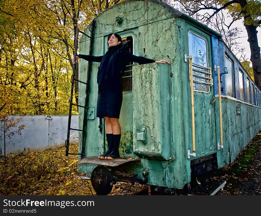 Woman strands on back side of old squalid rail coach. Woman strands on back side of old squalid rail coach