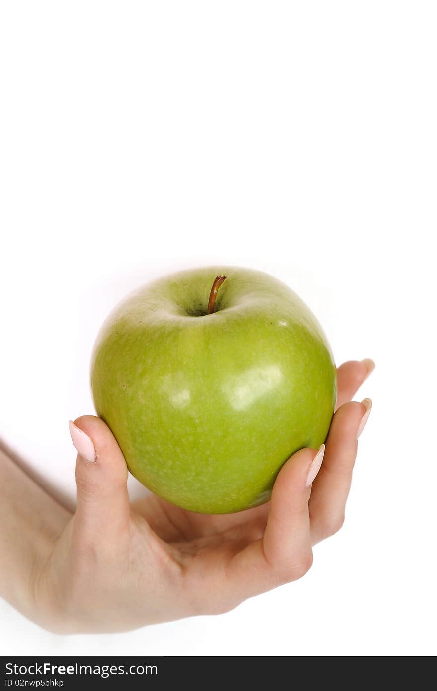 Green apple in a beautiful hand of woman