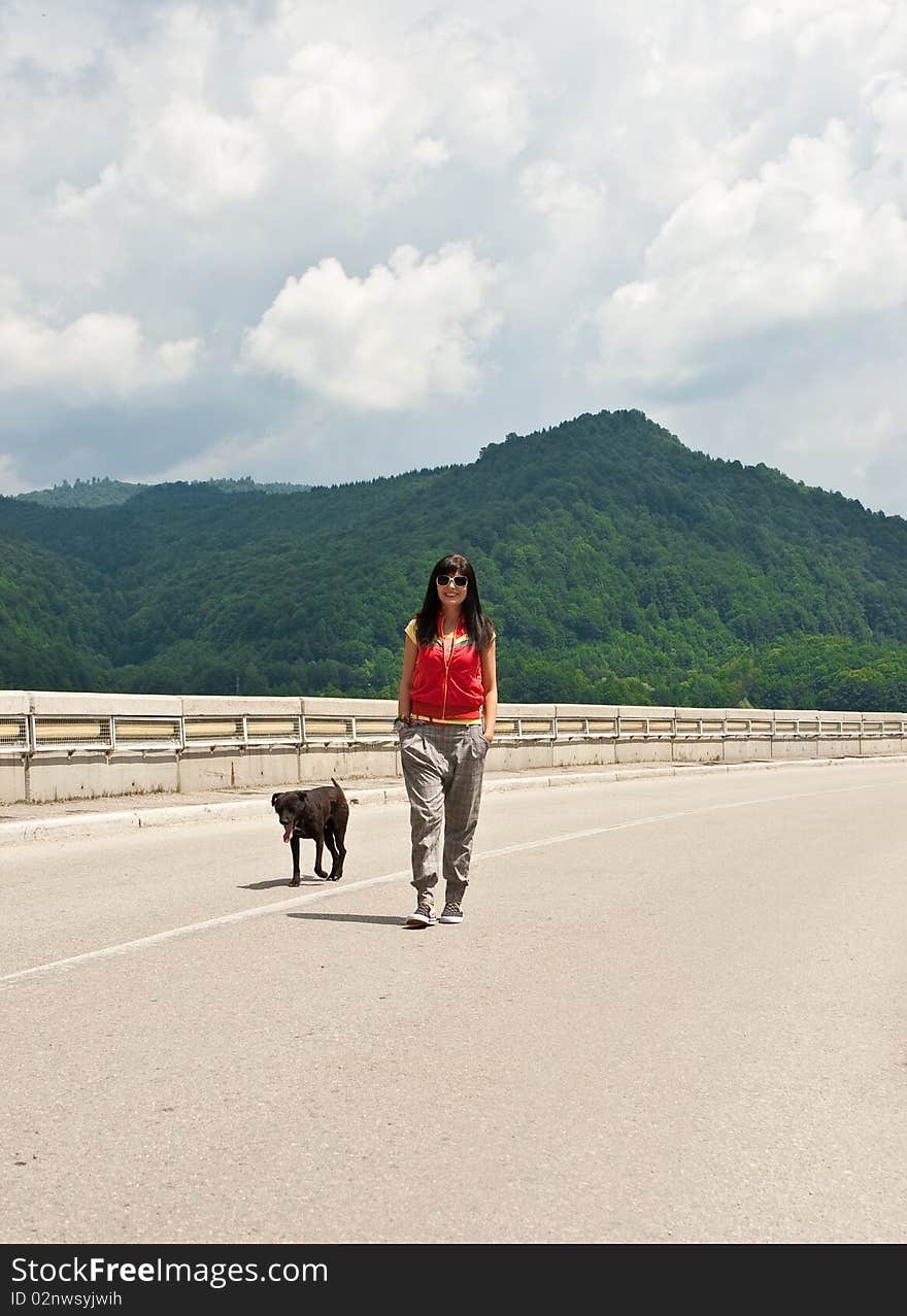 Cool girl walking on a mountain road