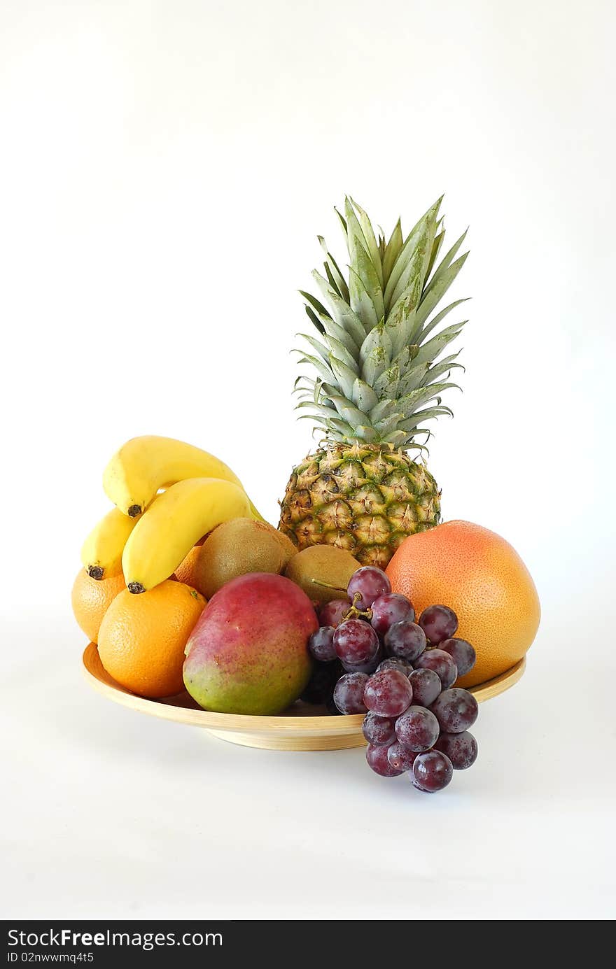 Plate of fruit noon on the white background. Plate of fruit noon on the white background