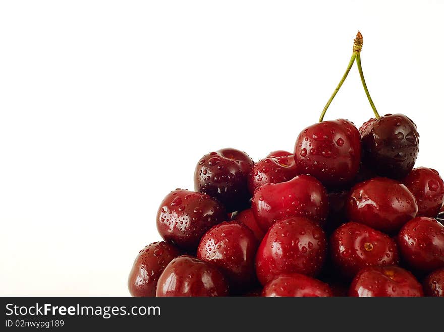 Sprinkled with water cherries on the white background. Sprinkled with water cherries on the white background