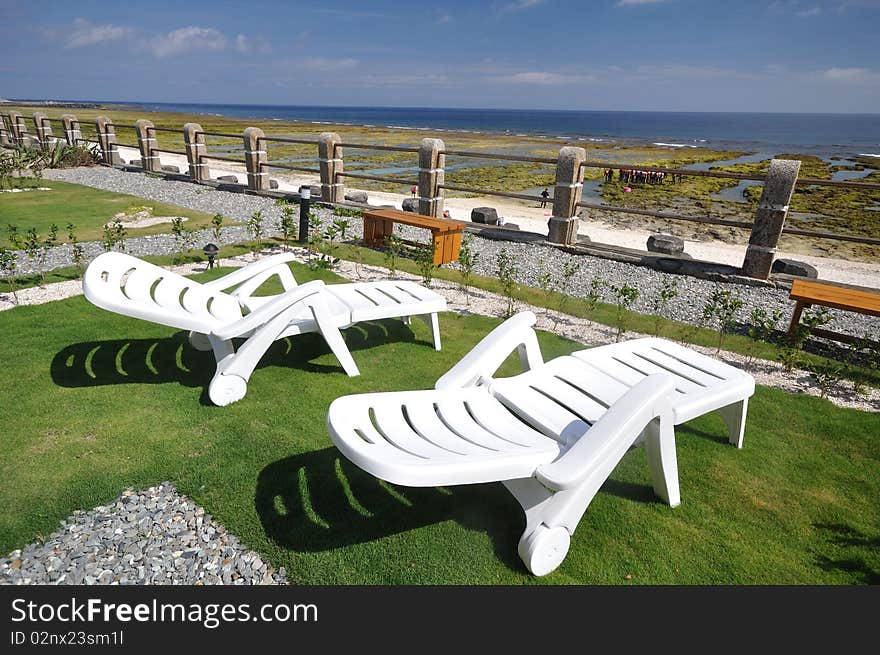 Two white chair set on the grassland. Two white chair set on the grassland