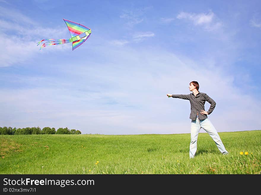 Young man in black shirt flying multicolored kite