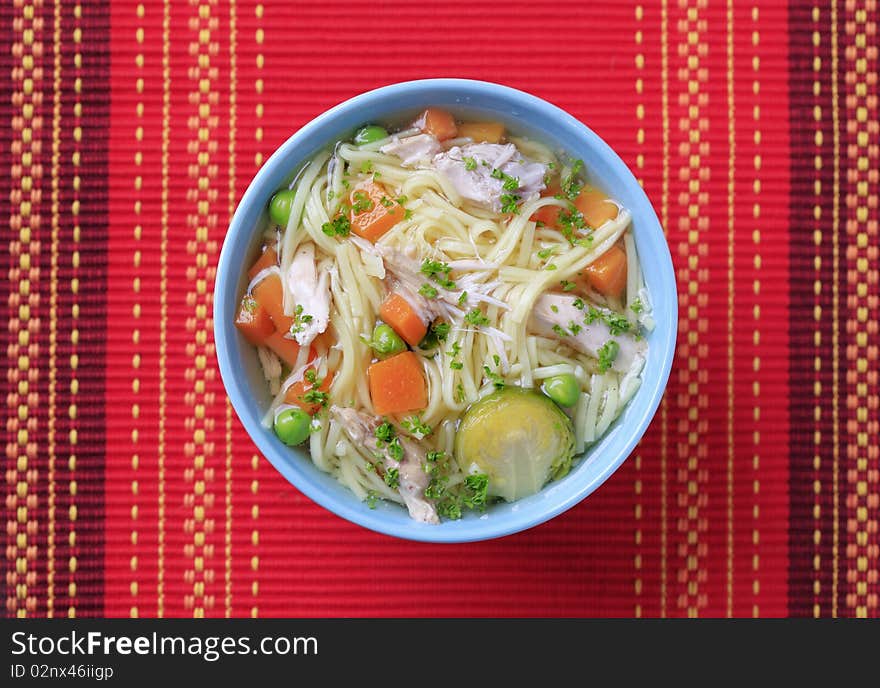 Bowl of chicken soup with noodles and vegetables