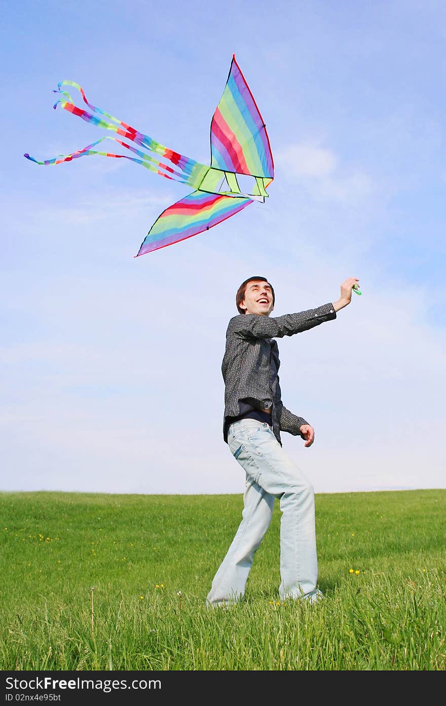 Young Man In Black Shirt Flying Multicolored Kite