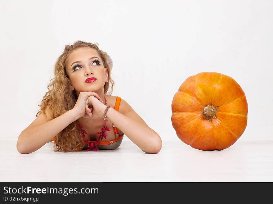 Young girl with a yellow pumpkin