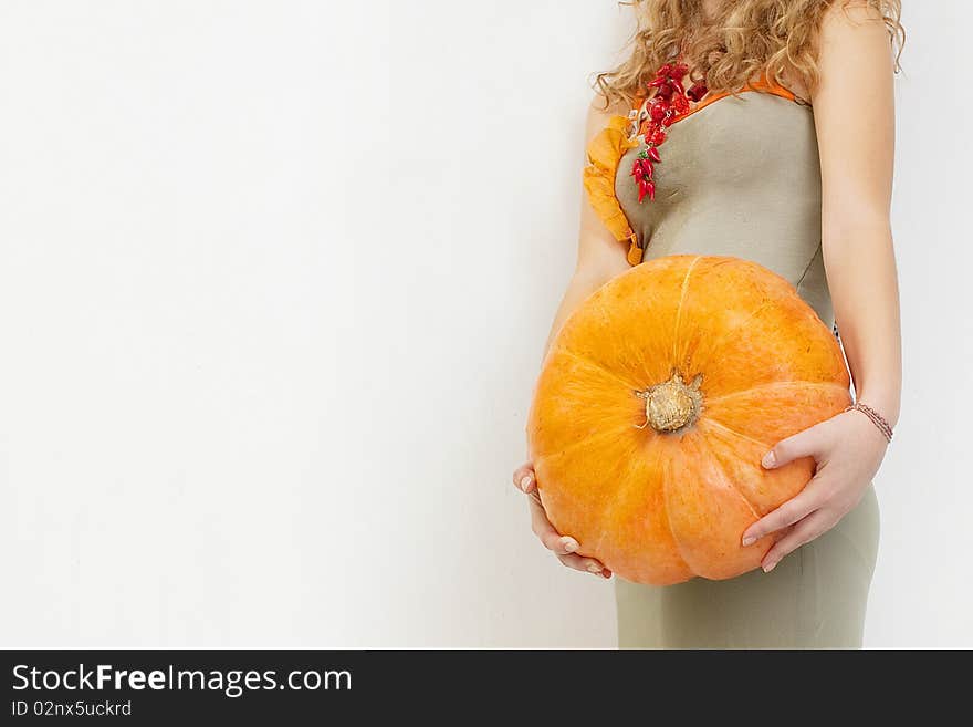 Young girl with a yellow pumpkin