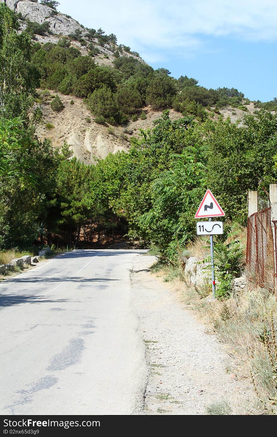 A road sign in the mountains of Crimea 11 sharp turns. Sudak. A road sign in the mountains of Crimea 11 sharp turns. Sudak.