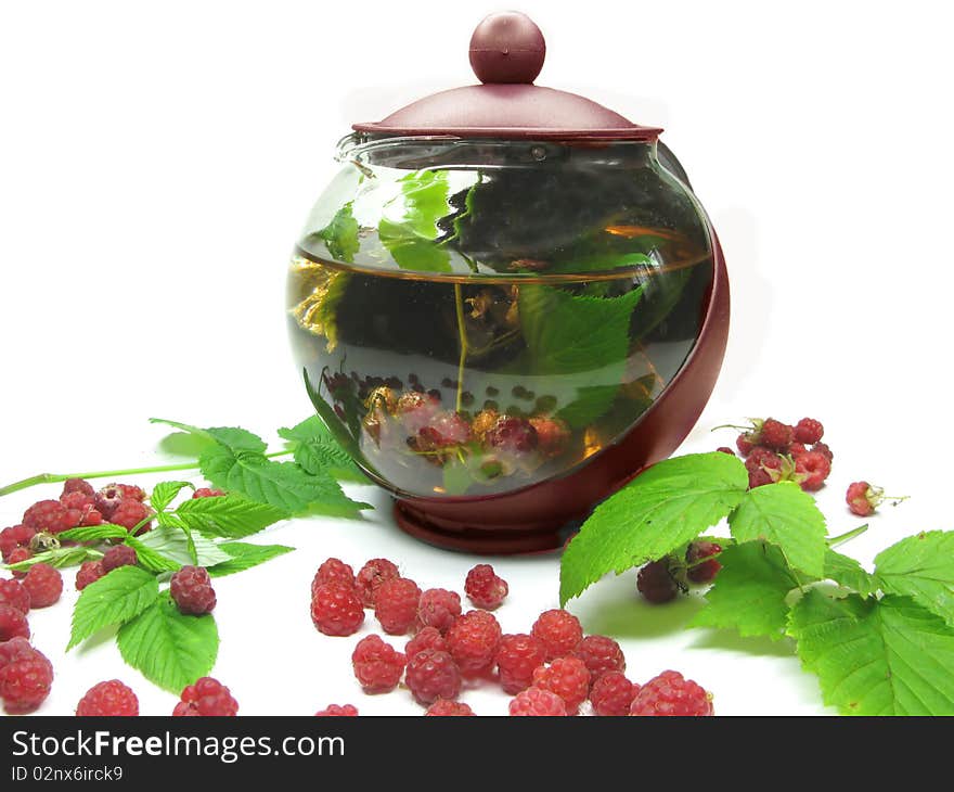 Tea-pot among forest fresh raspberry fruit. Tea-pot among forest fresh raspberry fruit