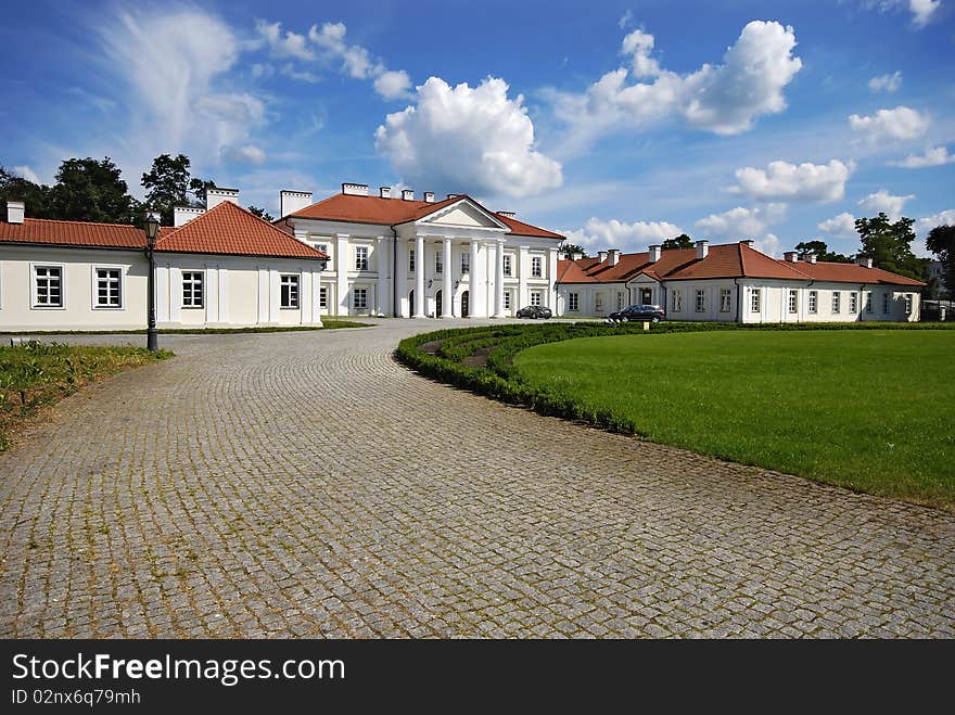 Classical palace with the garden into a sunny day