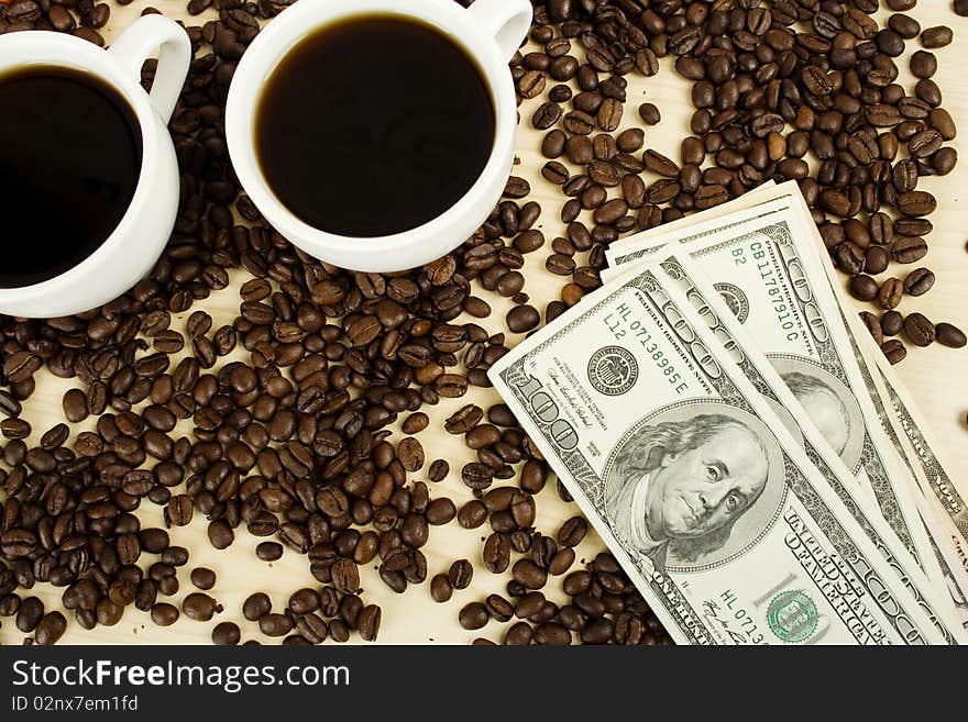 Aromatic coffee in white cup with coffee beans scattered and dollars. Aromatic coffee in white cup with coffee beans scattered and dollars