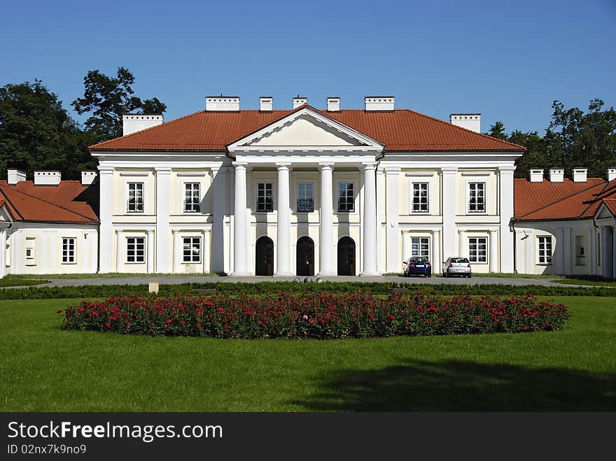 Classical palace with the garden into a sunny day