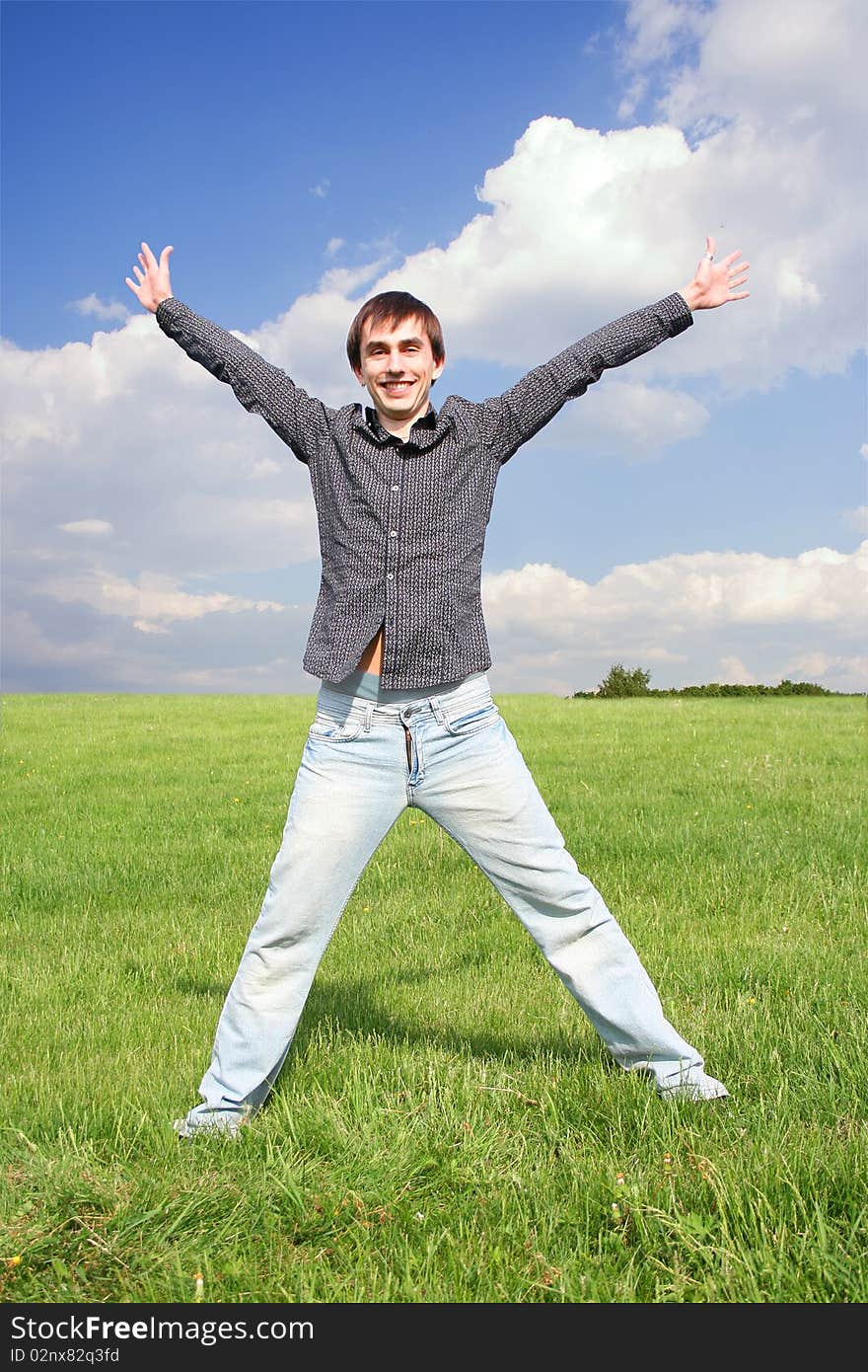 Young Man In Black Shirt Standing On Green Lawn