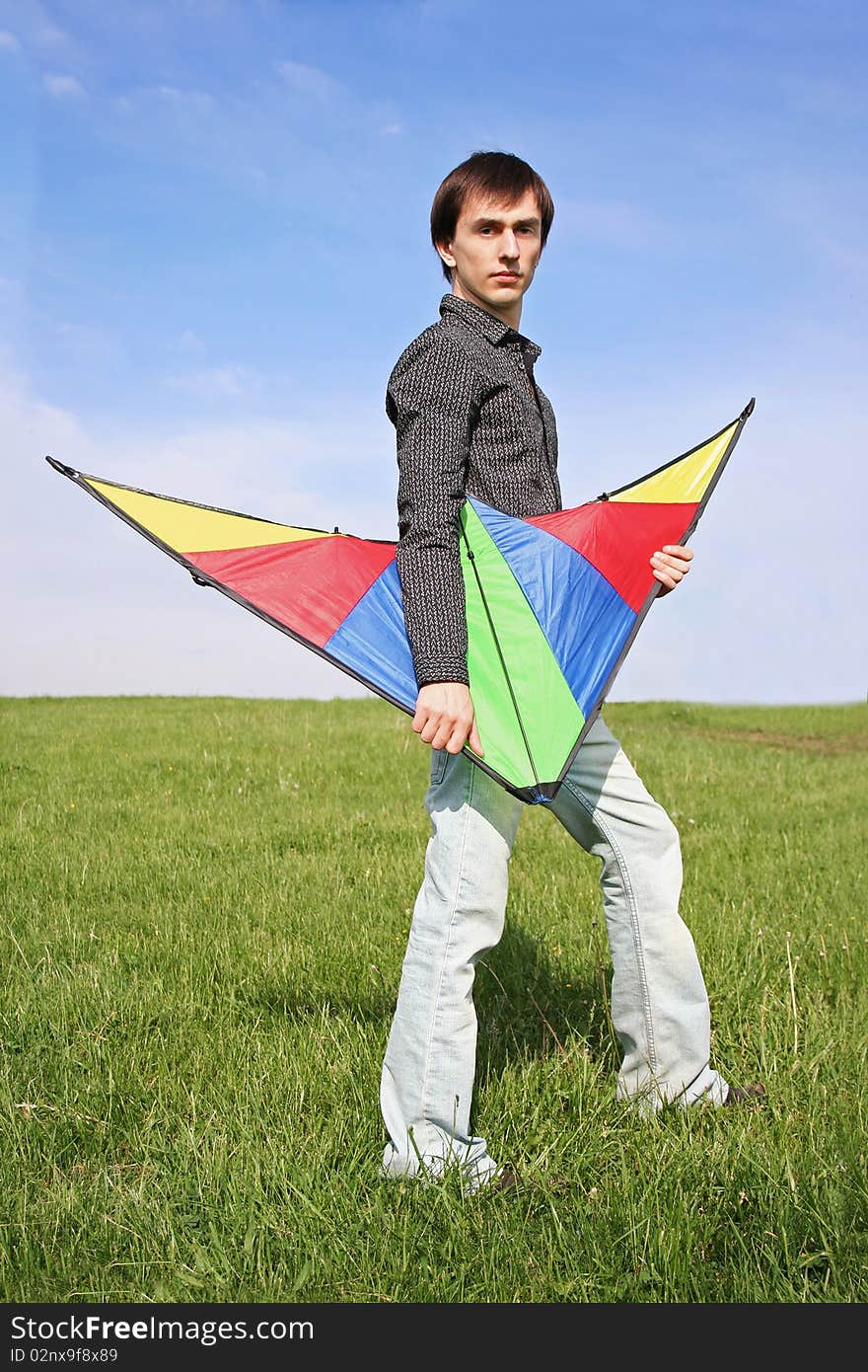 Young Man In Black Shirt Holding Multicolored Kite