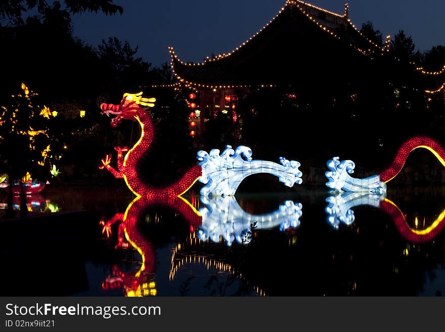 Chinese house architecture with decorative dragon lighting  at night. Chinese house architecture with decorative dragon lighting  at night