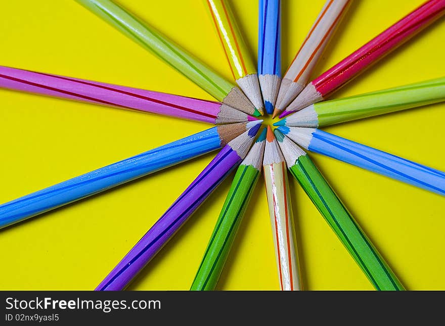 Colorful pencils on a bright yellow background. Colorful pencils on a bright yellow background.