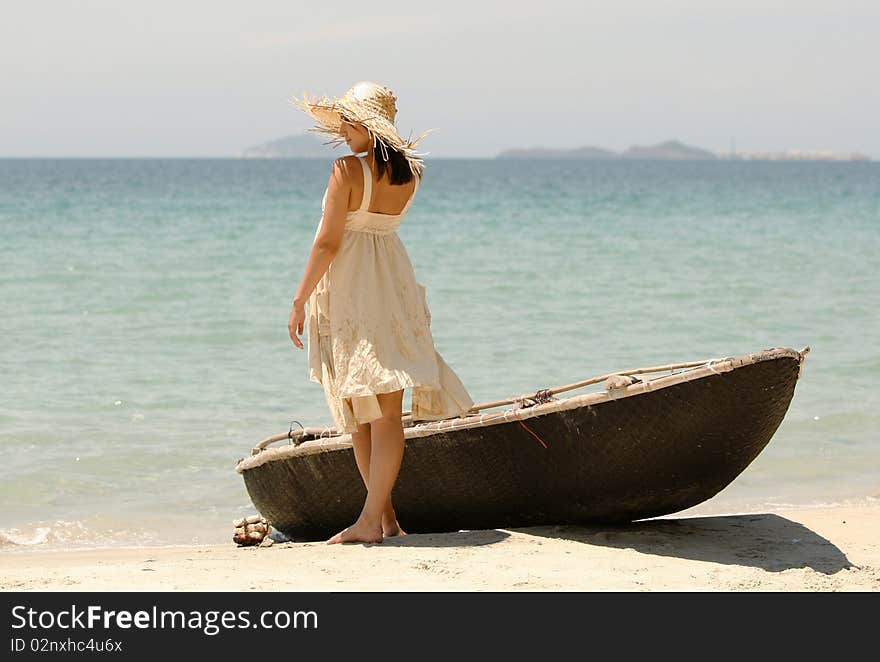 The beautiful girl at the sea near to a boat. The beautiful girl at the sea near to a boat